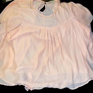 Cream or Peach Chiffon blouse with a button in the back around the neck.